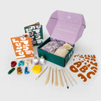 Contents of Good Mud letter kit with clay letters, stencils, tools and letter guide
