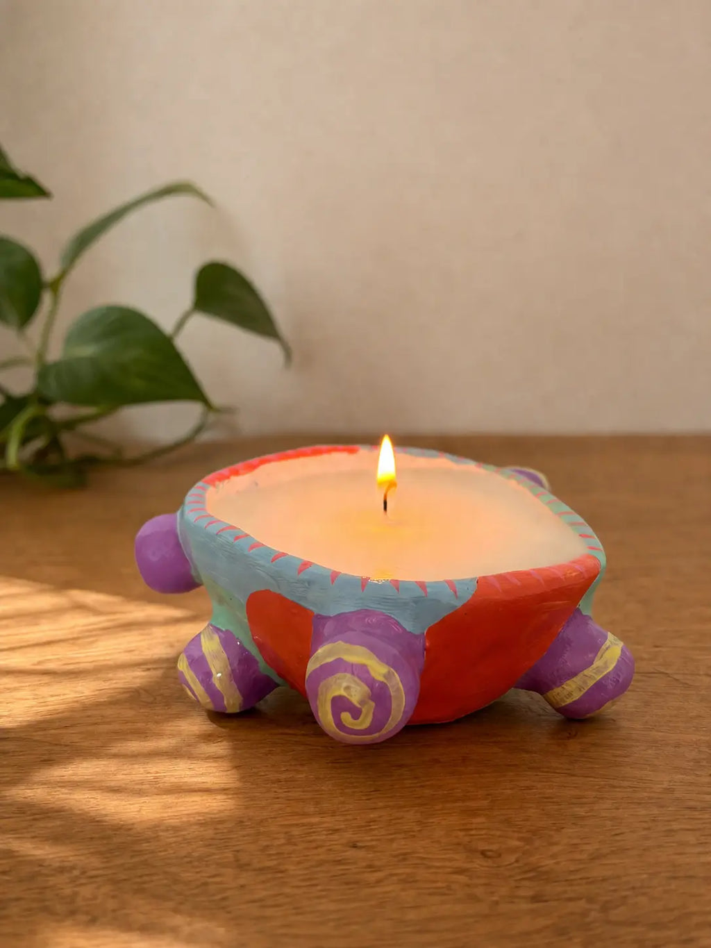 Finished candle in a handmade clay vessel
