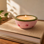 Handmade clay candle styled as home decor on books
