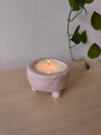 Finished candle in a handmade clay vessel