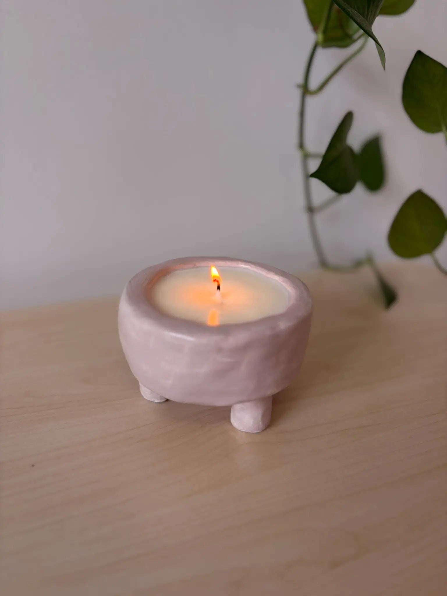 Finished candle in a handmade clay vessel