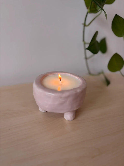 Finished candle in a handmade clay vessel