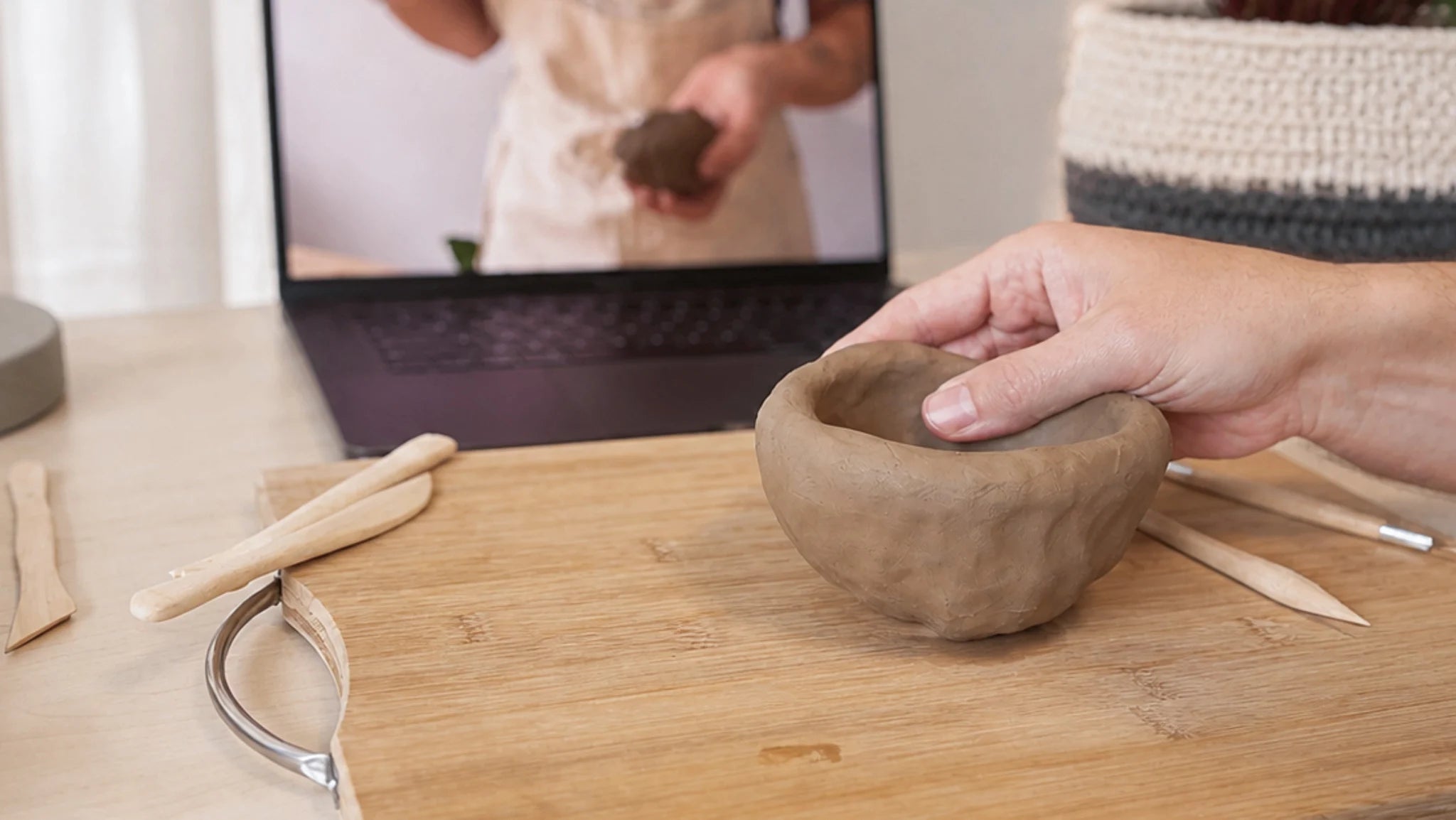 Shaping a clay bowl during a team building pottery activity